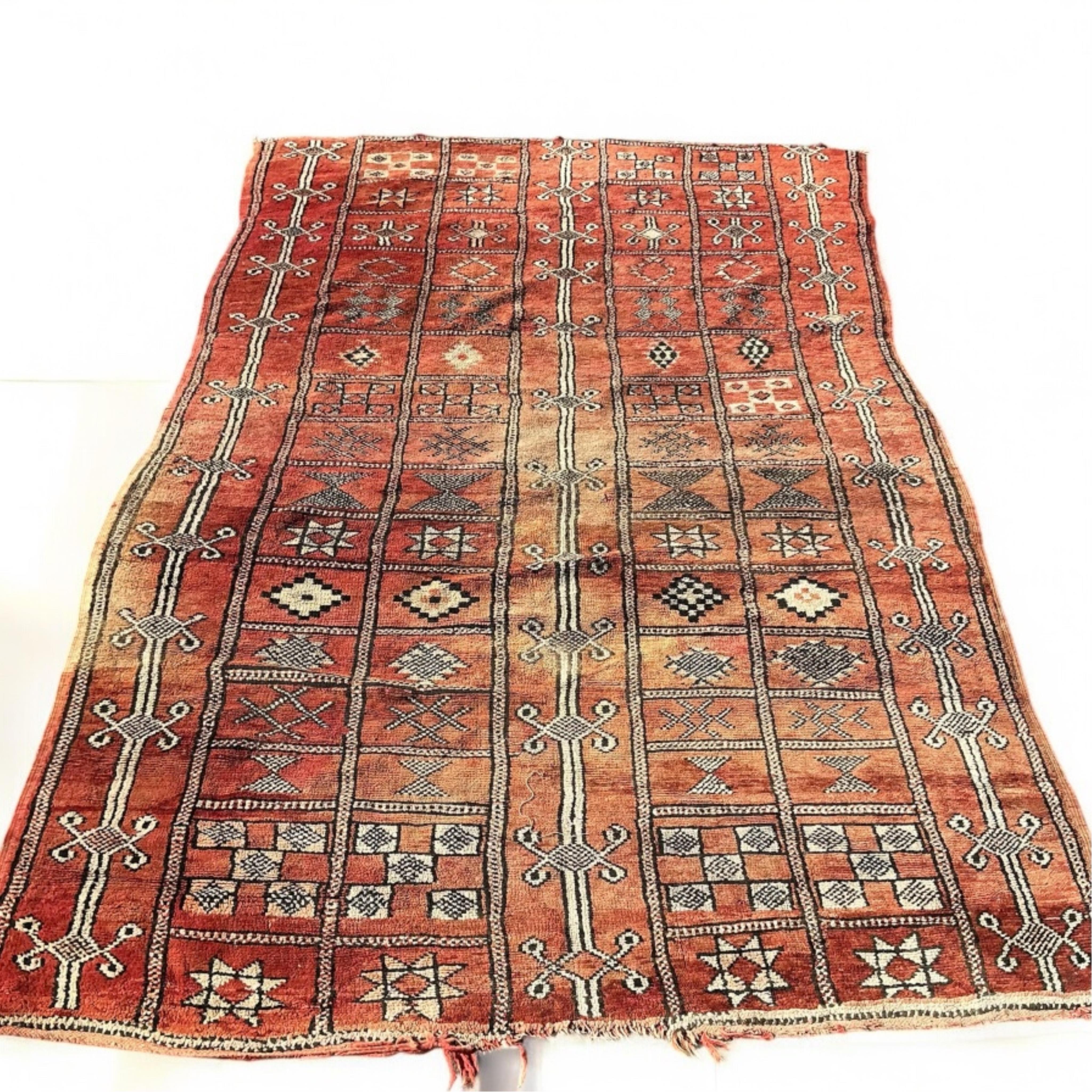 A Moroccan Berber pale red ground carpet, 300 x 190cm